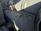 a seat in the back of a car with a remote control