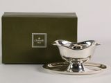 a silver plate with a saucer and saucer on it