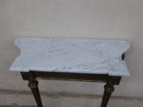 a marble top table with a gold frame on it