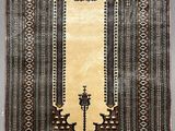an old rug with a mirror and two candles on it