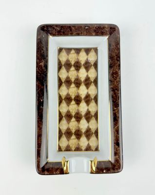 brown and white checkered glass plate with gold trim