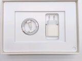 a white box with a charger and a cable in it