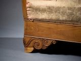a bed with a wooden frame and a beige upholstered cover