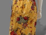an image of a mannequin wearing a yellow skirt with flowers on it