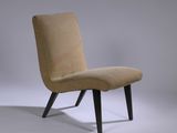 une chaise rembourrée avec des pieds en bois et une assise rembourrée de couleur beige clair