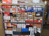 a metal cart with many boxes on it in a warehouse