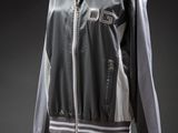 an image of a black and white jacket on a mannequin stand