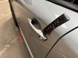 a sticker on the door handle of a car