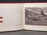 an open book with a picture of a boat and a letter f on it