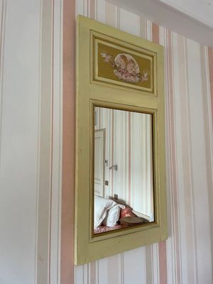 a mirror hanging on the wall above a bed
