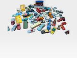 a pile of toy cars on a white surface