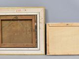 two wooden frames with a painting hanging on a wall next to each other