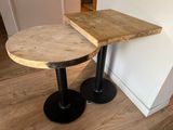 two tables that are sitting next to each other on the floor