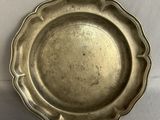 a silver plate that is on a white table