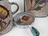 three different types of pottery on display on the table