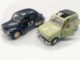 two toy cars sitting next to each other on a white surface