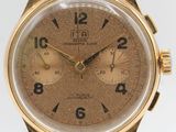 a close up of a gold wrist watch on a black leather strap