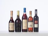 several bottles of wine are lined up on a table