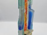 a glass sculpture of a building with a bird on top of it