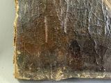 a piece of wood that has been scratched and is sitting on a table