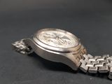 a close up of a watch on a black surface
