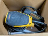 a box with a cord and a cord cutter in it