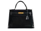 a black leather handbag on a white background
