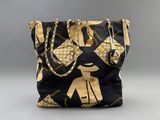 an image of a black and gold purse with chains on it