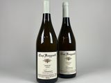 two bottles of wine sitting next to each other on a table