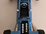 a model of a blue race car on a white surface