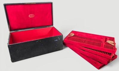 a red box with four red combs in it and a red box with four red combs in it