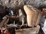 a pile of luggage sitting on top of a wooden cart