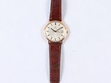 a close up of a watch on a white surface with a white background