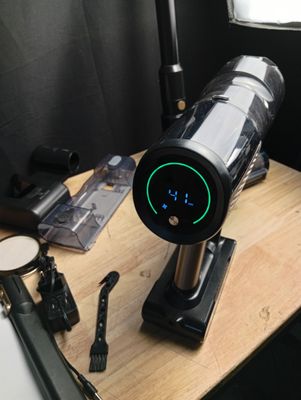 a coffee maker sitting on a table with a clock on it