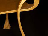 a wooden table with a curved design on it