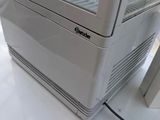 a white refrigerator sitting on top of a white counter