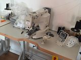 two sewing machines sitting on a table in a room