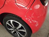 a close up of a red car with black rims