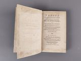 an open book with writing on it sitting on top of a table