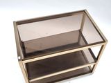 an image of a glass and brass display case on a white background