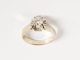 a picture of a diamond ring on a white surface