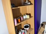 a shelf that has many cups and mugs on it