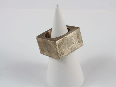 a white cone with a gold ring on top of it