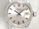 a close up of a watch on a table with a white background