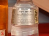 a bottle of water and a bottle of liquid on a table