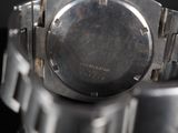 a close up of a watch on a black surface
