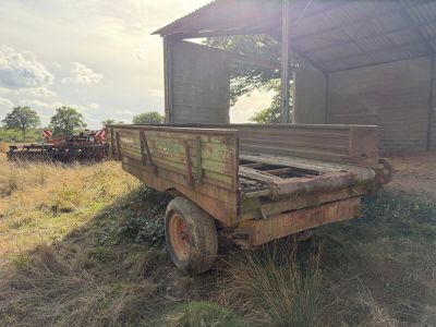 a old truck that is sitting in the grass