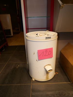 a white trash can sitting on the floor next to a cardboard box