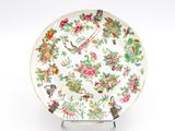 a plate with a bird and flowers design on it