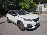 a white car that is parked on the side of the road